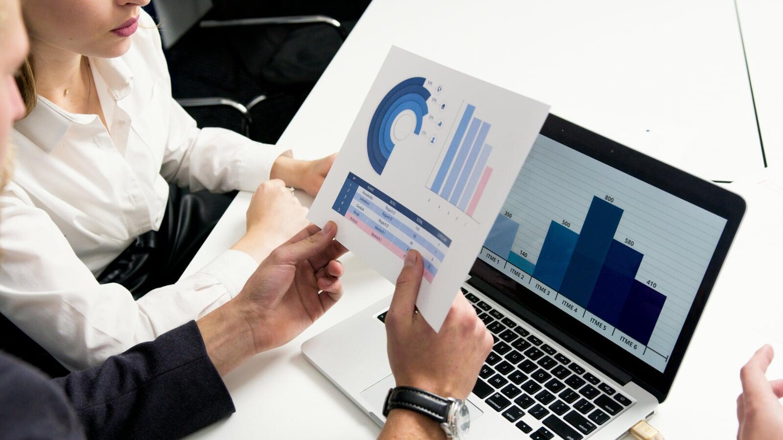 People analysing graphs and statistics deciding on the best course of action.